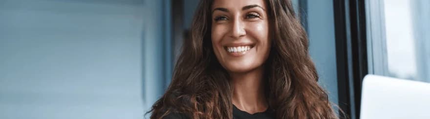 a woman smiling learning about the use cases of AI based skills practice simulations