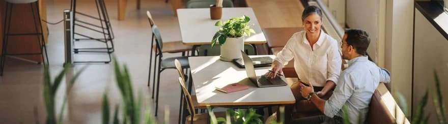 A women sitting at a desk with a laptop with her